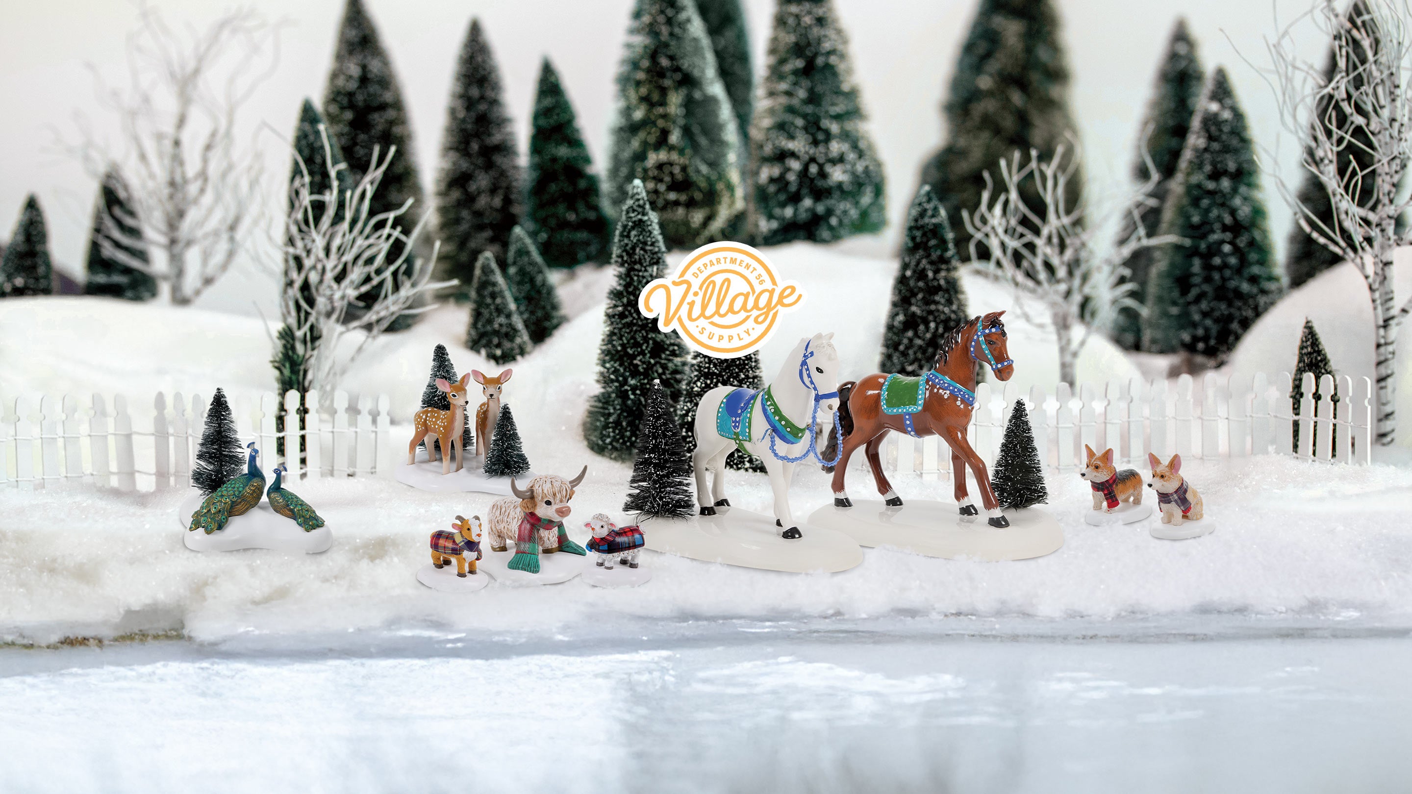 Model village scene with animals and trees in a snowy landscape, featuring the 'Village' brand logo.