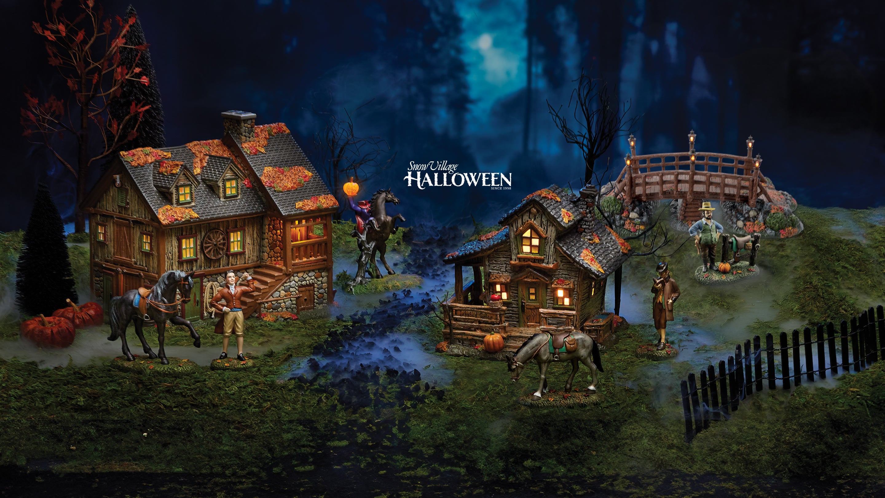 Halloween-themed diorama with village houses and figures in a forest setting.