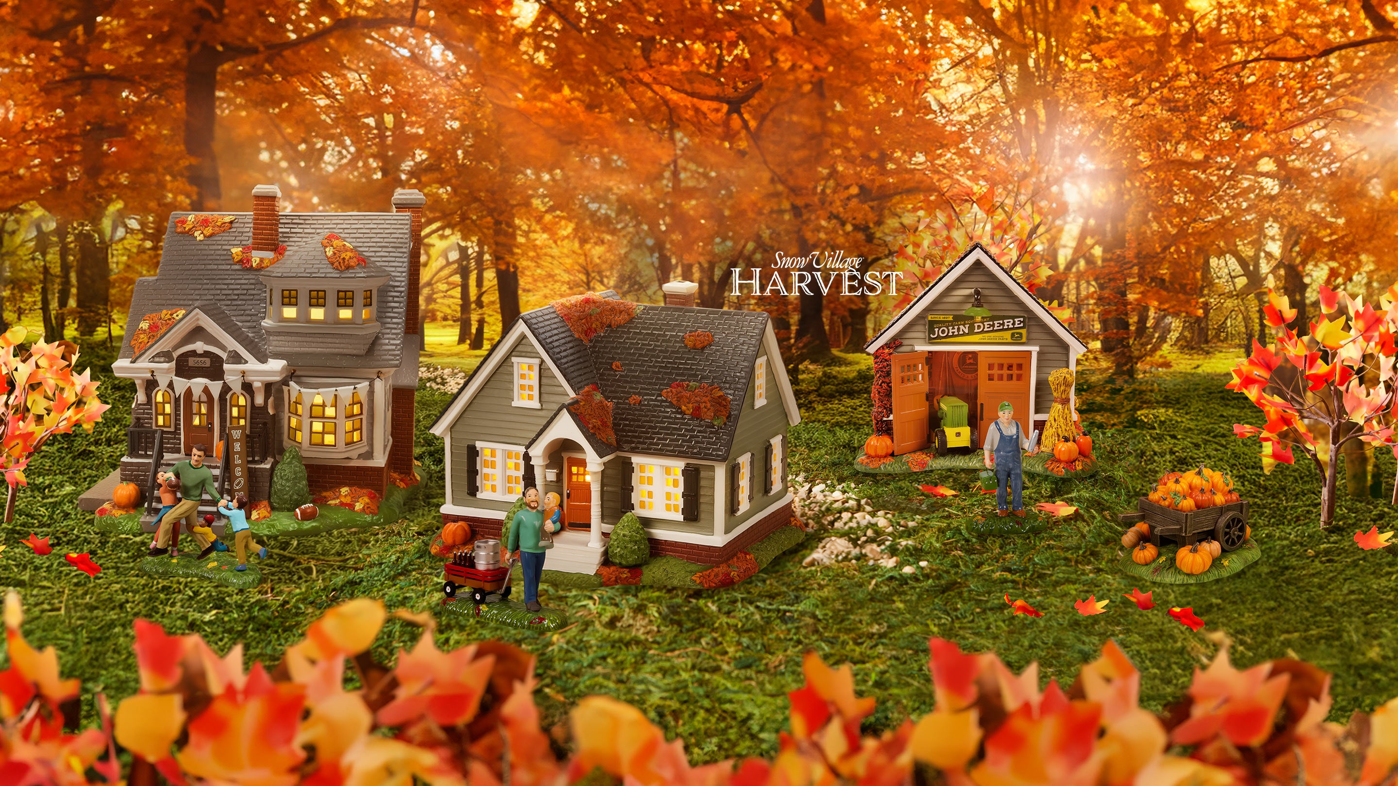 Miniature model of a village with houses and people in an autumn setting.